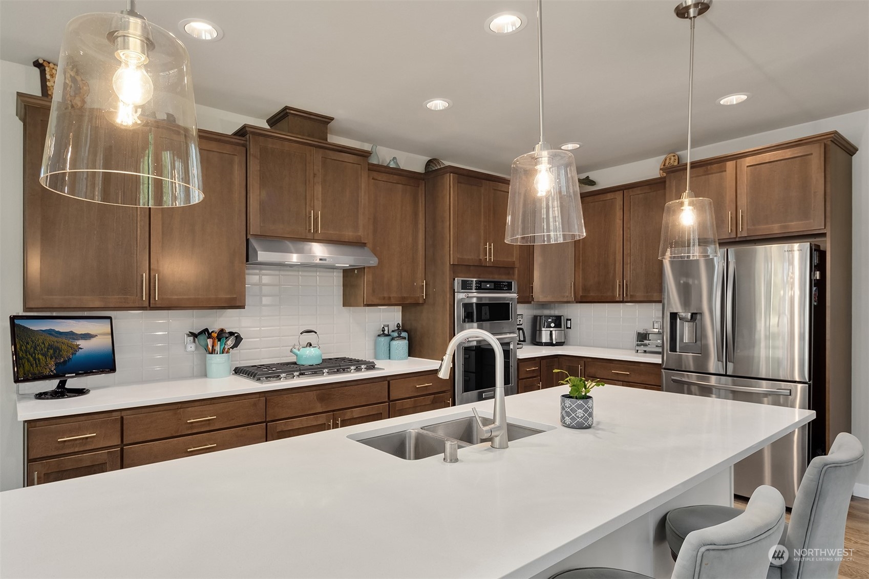 4331 Caddyshack Drive Northeast Lacey, WA 98516 - Photo 14 of 34 a kitchen with kitchen island a sink appliances and cabinets