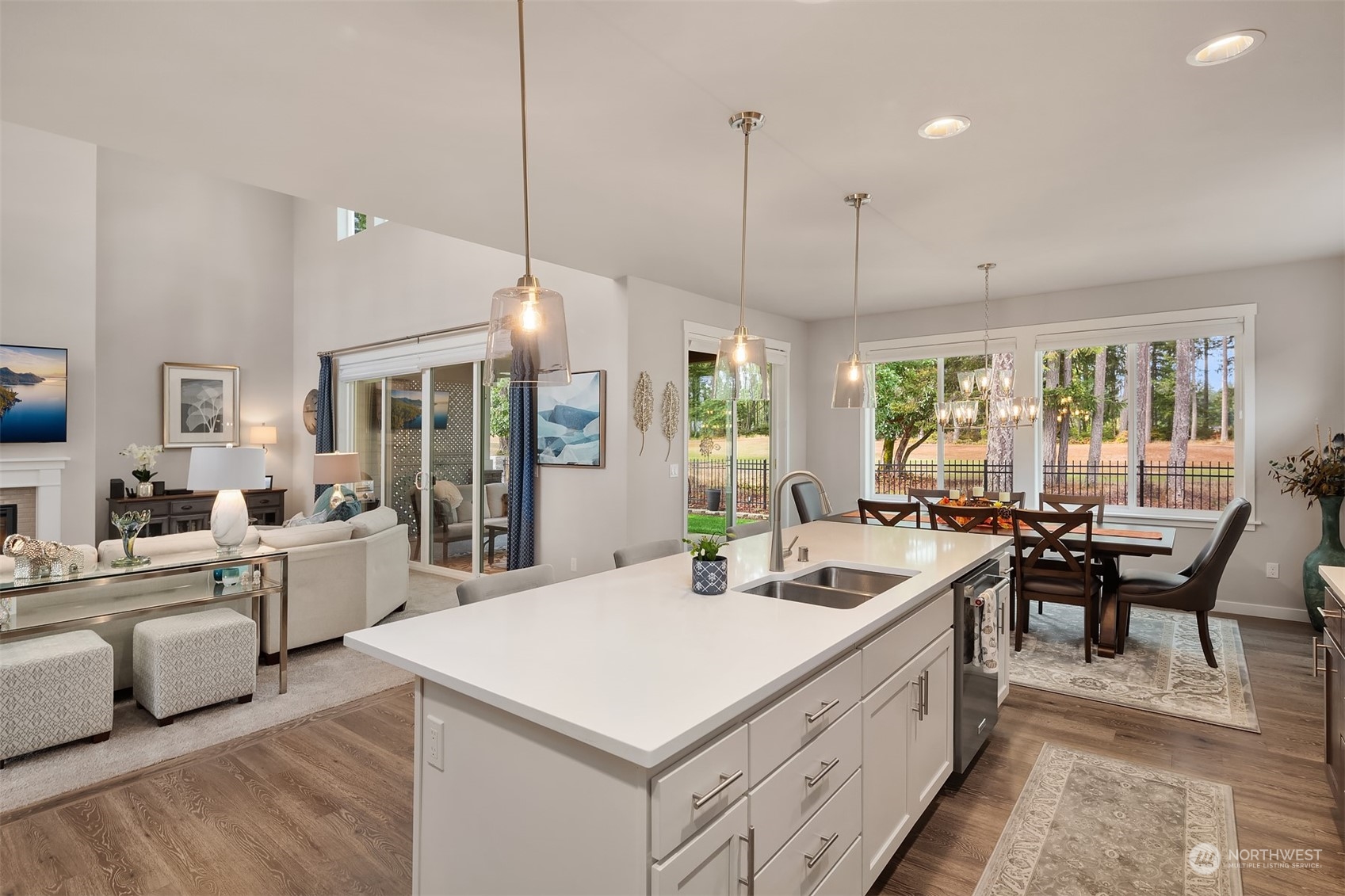 4331 Caddyshack Drive Northeast Lacey, WA 98516 - Photo 7 of 34 a large white kitchen with a table and chairs