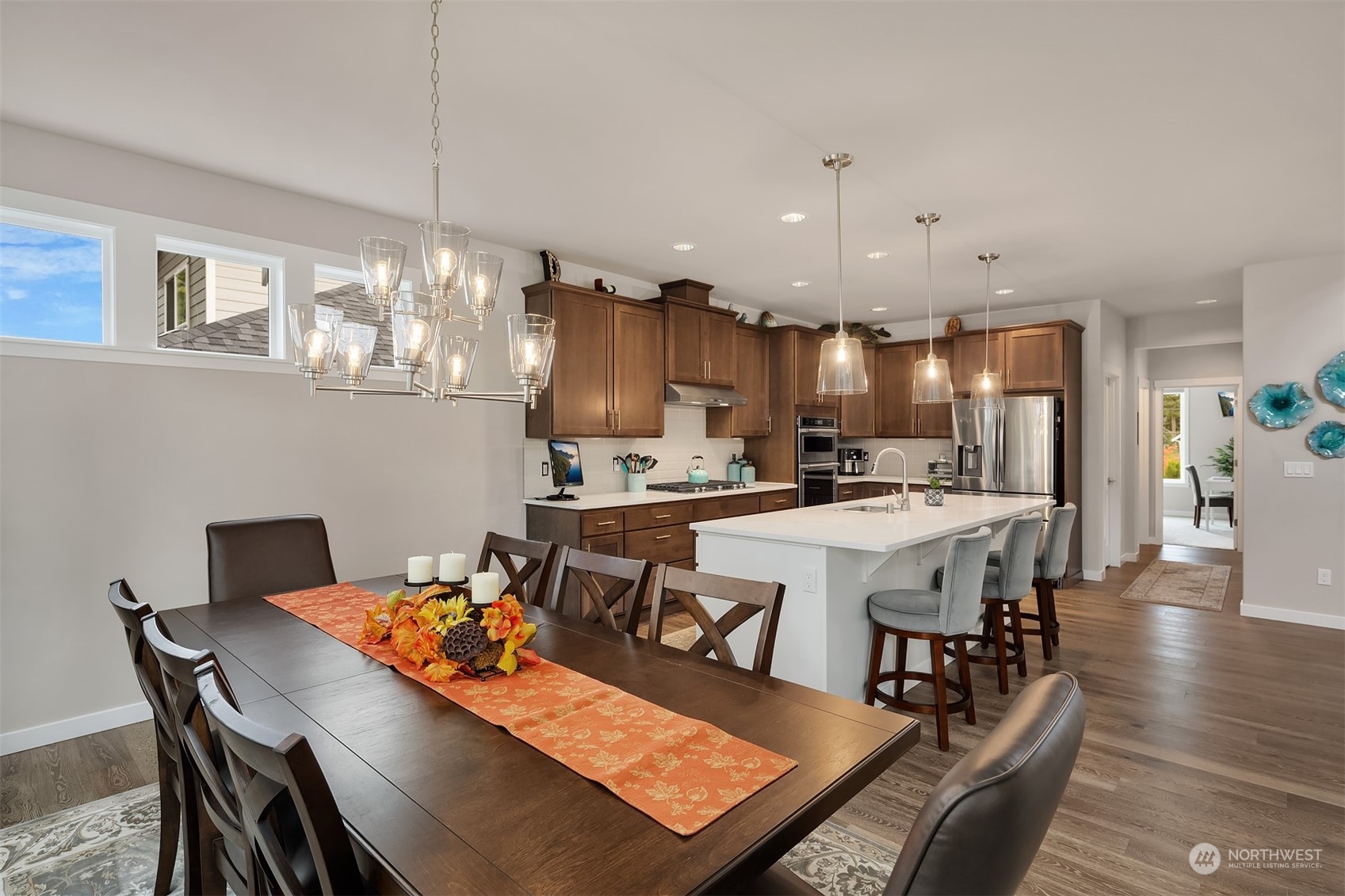 4331 Caddyshack Drive Northeast Lacey, WA 98516 - Photo 9 of 34 a view of a dining room and livingroom with furniture a chandelier and wooden floor