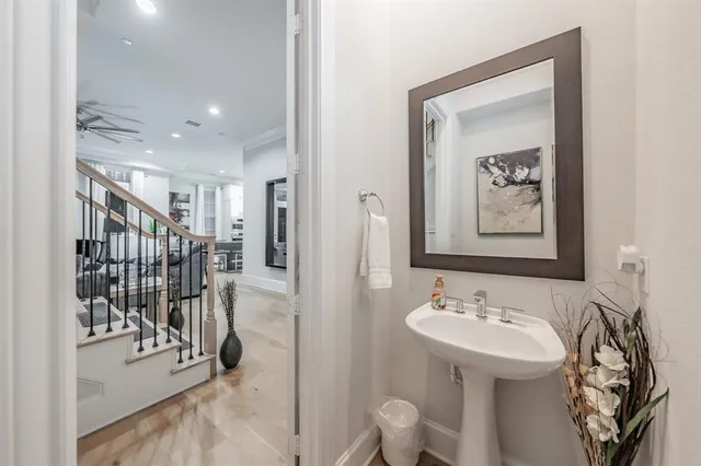 a spacious bathroom with a double vanity sink a mirror a bathtub and shower