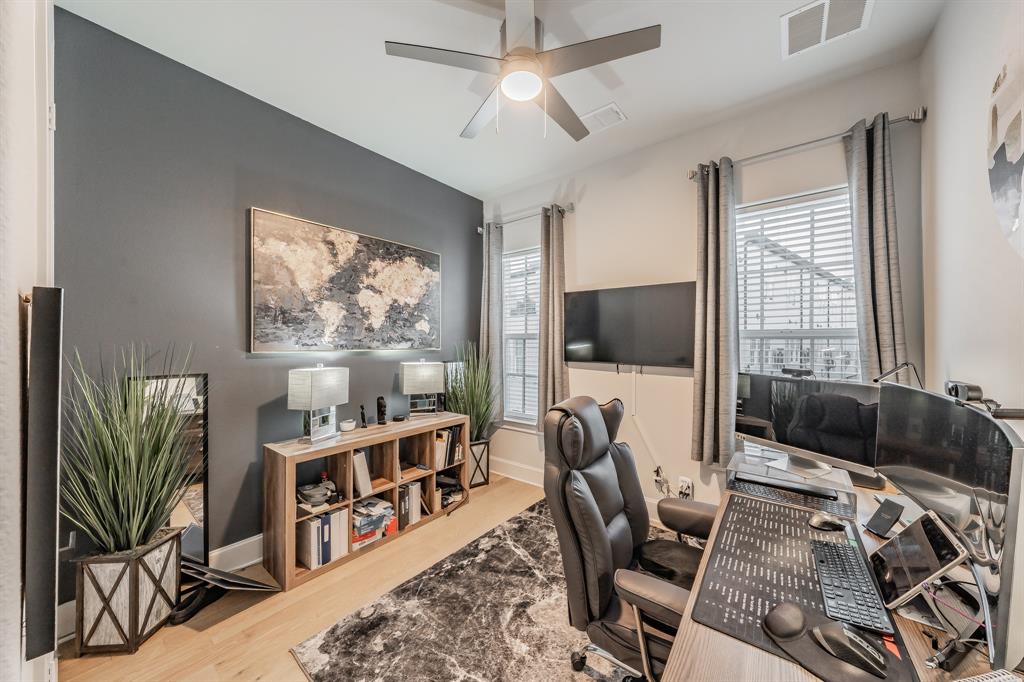 7333 Valley View Lane, Unit 902 Dallas, TX 75240 - Photo 17 of 40 a living room with furniture a flat screen tv and a floor to ceiling window