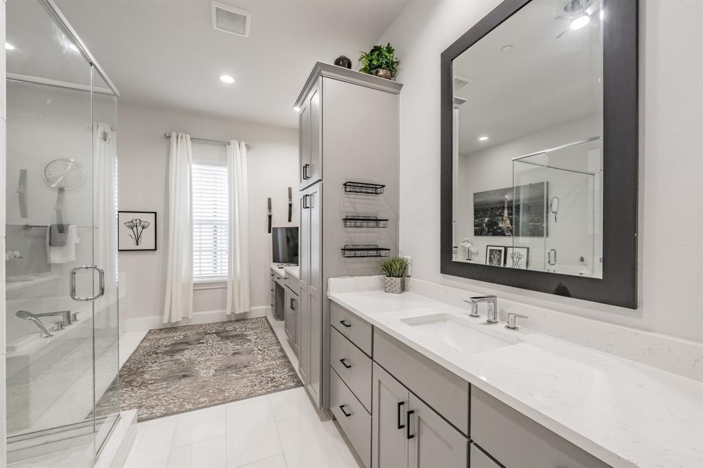 7333 Valley View Lane, Unit 902 Dallas, TX 75240 - Photo 21 of 40 a spacious bathroom with a shower sink and mirror