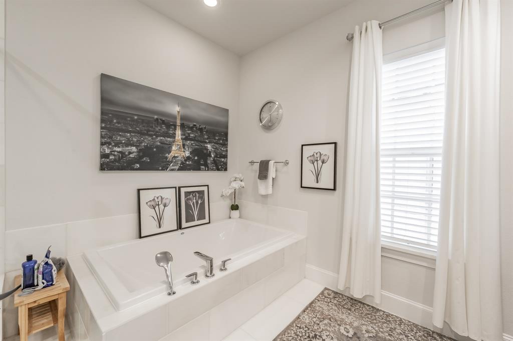 7333 Valley View Lane, Unit 902 Dallas, TX 75240 - Photo 24 of 40 a bathroom with a bathtub and a window
