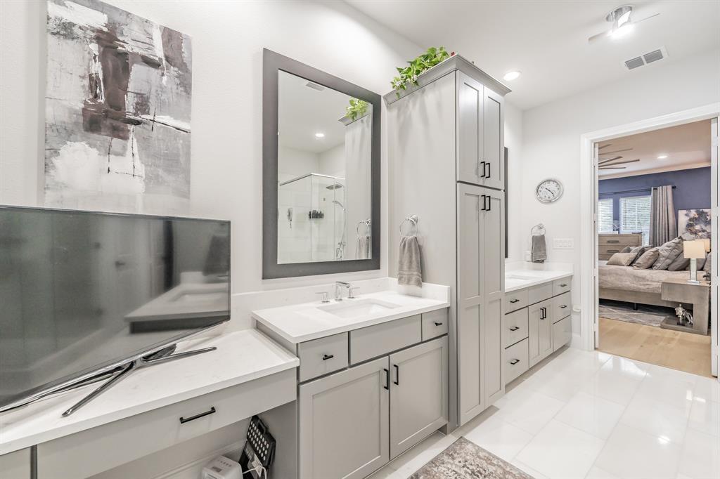 7333 Valley View Lane, Unit 902 Dallas, TX 75240 - Photo 25 of 40 a spacious bathroom with a double vanity sink a large mirror and a shower