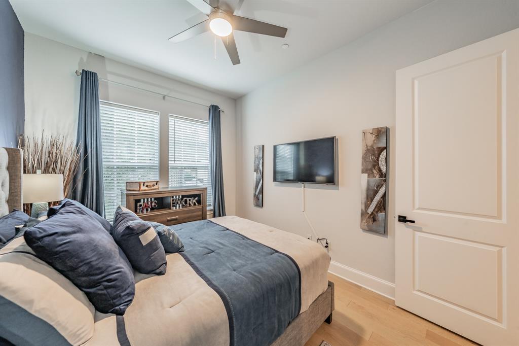 7333 Valley View Lane, Unit 902 Dallas, TX 75240 - Photo 27 of 40 a bedroom with a bed and a flat screen tv