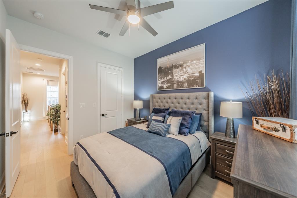 7333 Valley View Lane, Unit 902 Dallas, TX 75240 - Photo 28 of 40 a bedroom with a bed and a chandelier