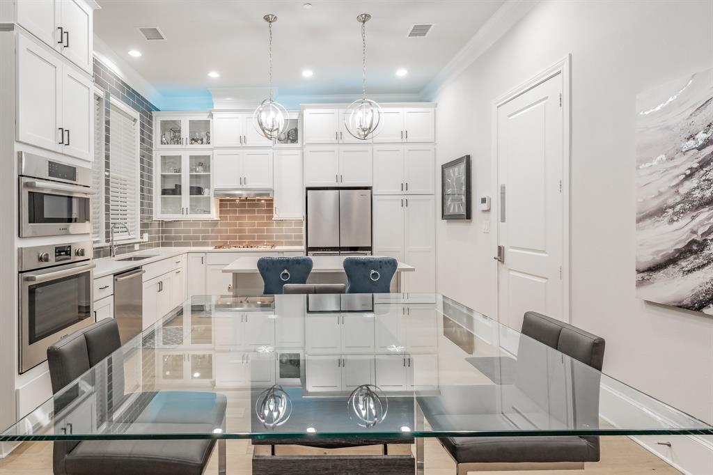 7333 Valley View Lane, Unit 902 Dallas, TX 75240 - Photo 3 of 40 a kitchen with stainless steel appliances kitchen island granite countertop a refrigerator and microwave