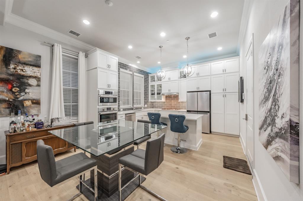 7333 Valley View Lane, Unit 902 Dallas, TX 75240 - Photo 6 of 40 a large kitchen with stainless steel appliances kitchen island granite countertop a sink and cabinets