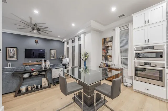a large kitchen with kitchen island a dining table and chairs
