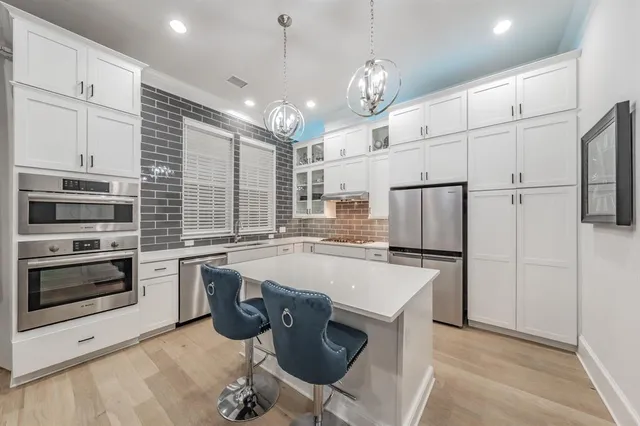 a large white kitchen with a large window