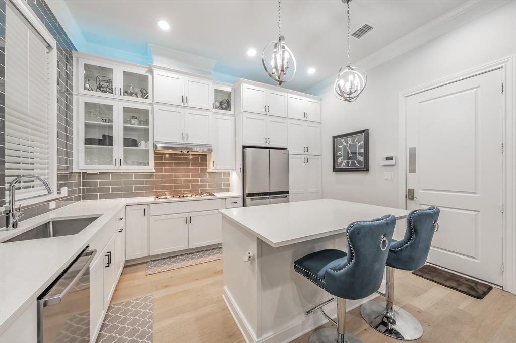 7333 Valley View Lane, Unit 902 Dallas, TX 75240 - Photo 10 of 40 a large kitchen with kitchen island a dining table and chairs