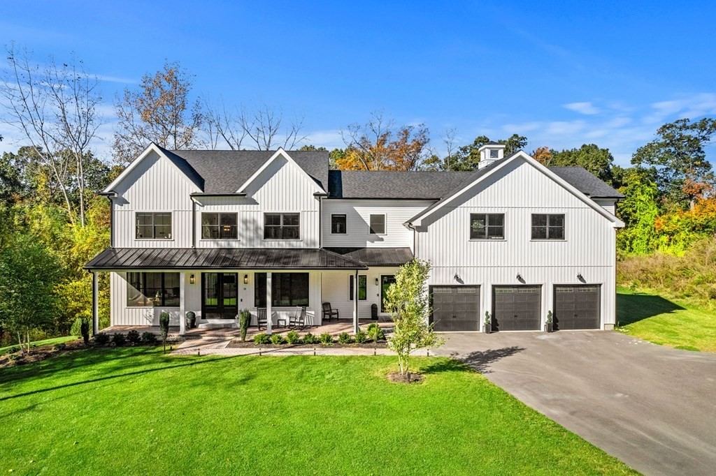 a front view of a house with a yard table and chairs