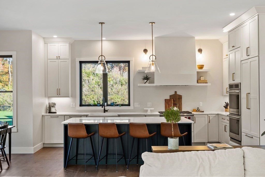 35 Hitching Post Road North Andover, MA 01845 - Photo 14 of 42 a kitchen with stainless steel appliances granite countertop a sink window and chairs