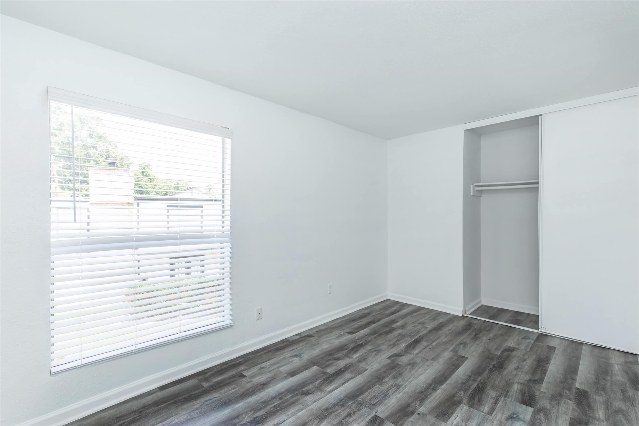 18001 Cypress Trace Road, Unit 201 Houston, TX 77090 - Photo 12 of 31 a view of an empty room with wooden floor and a window
