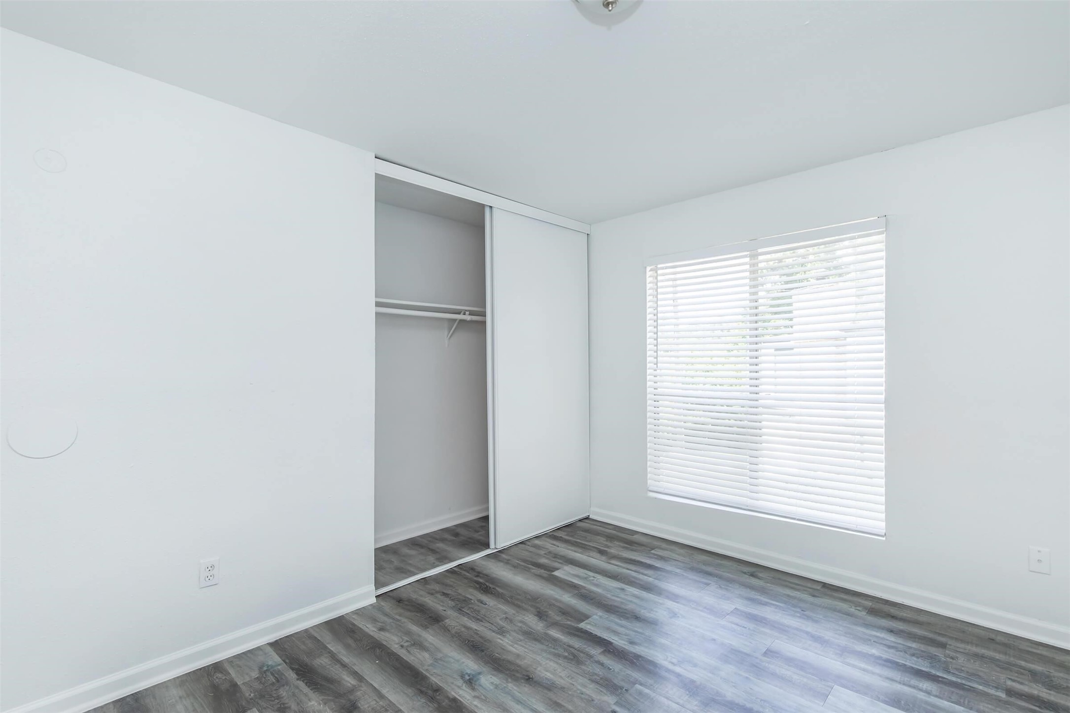 18001 Cypress Trace Road, Unit 201 Houston, TX 77090 - Photo 15 of 31 a view of an empty room with wooden floor and a window