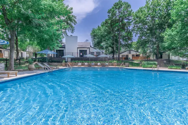 a view of a house with swimming pool and sitting area