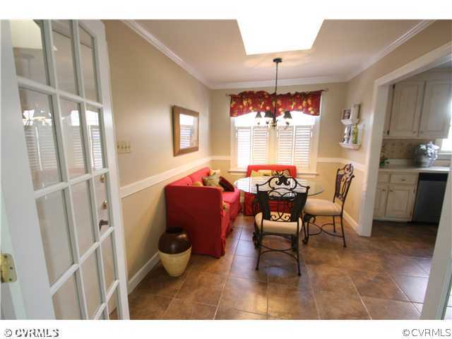 1900 Winterfield Road Midlothian, VA 23113 - Photo 8 of 12 a dining room with furniture a chandelier and wooden floor