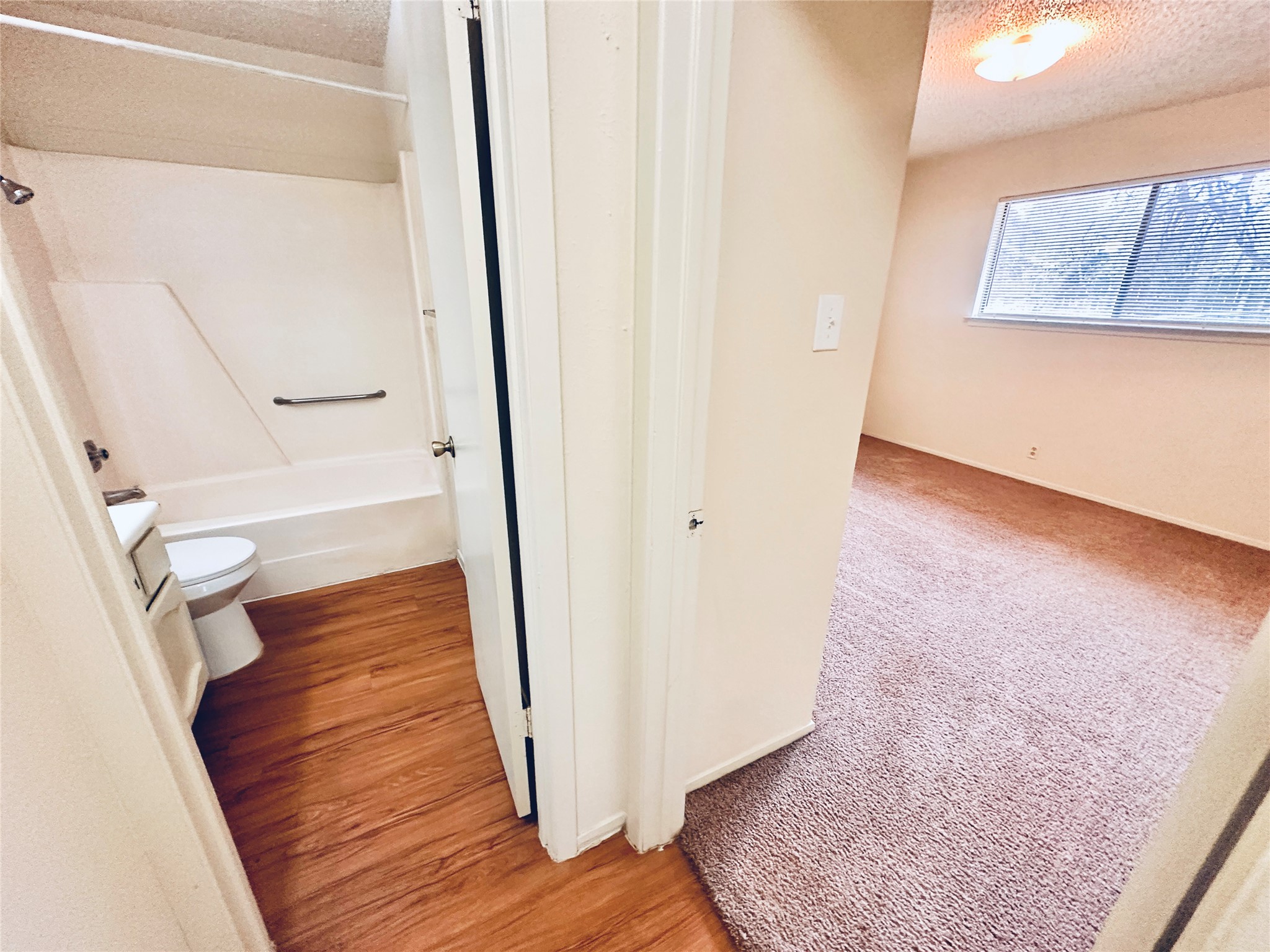 12504 Tree Line Drive, Unit B Austin, TX 78729 - Photo 18 of 22 Full bathroom with vanity, a textured ceiling, shower / tub combination, and light colored carpet