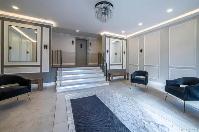 a living room with furniture and a chandelier