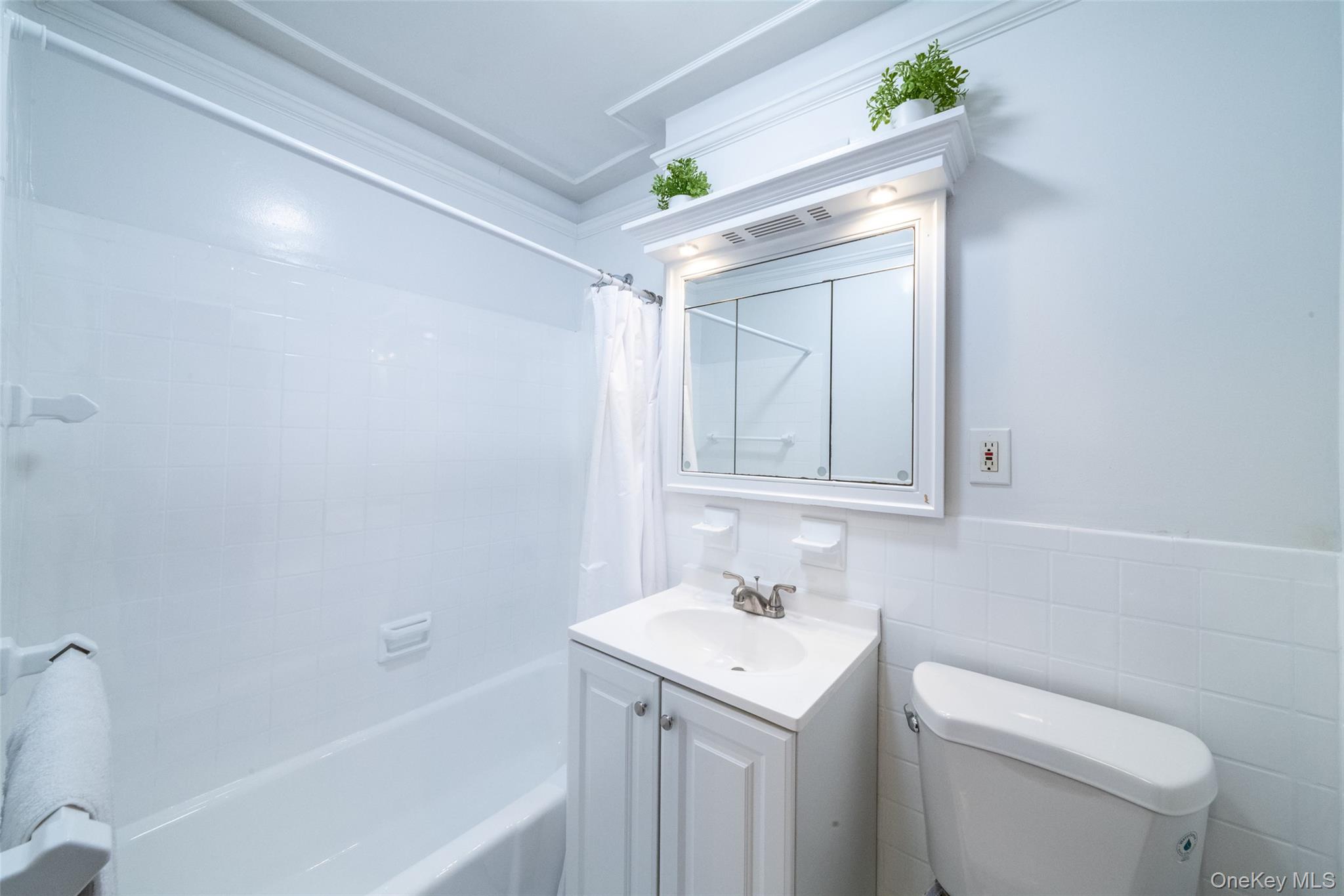 2221 Palmer Avenue, Unit 3D New Rochelle, NY 10801 - Photo 7 of 18 a bathroom with a sink a toilet and shower