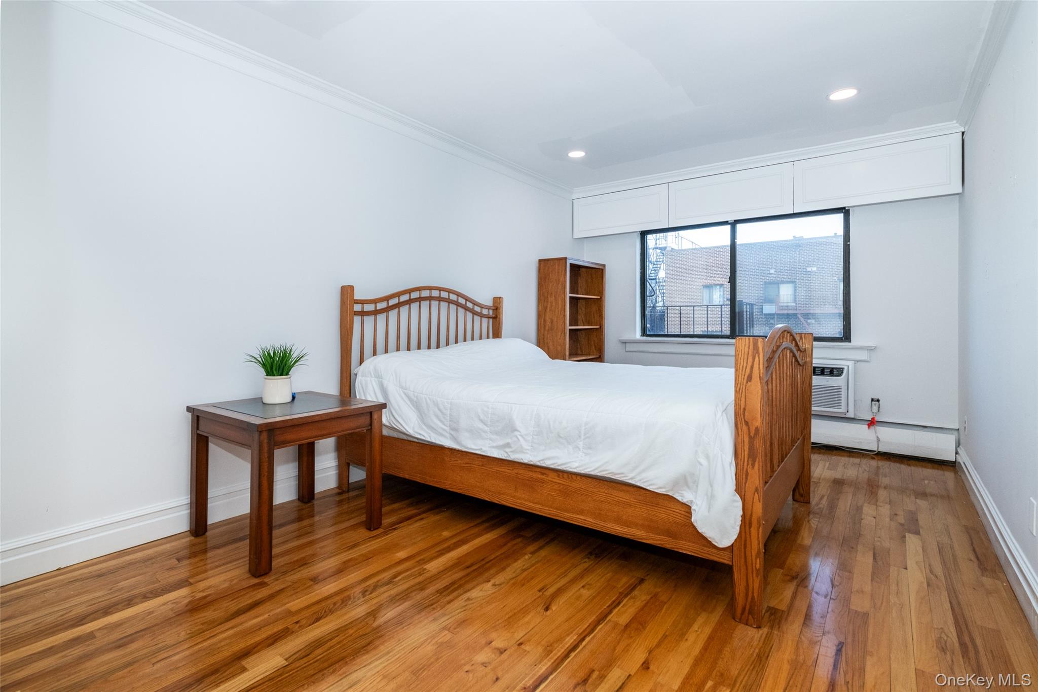 2221 Palmer Avenue, Unit 3D New Rochelle, NY 10801 - Photo 8 of 18 a bedroom with a bed and wooden floor