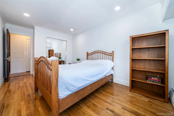 a bed room with a bed and a book shelf
