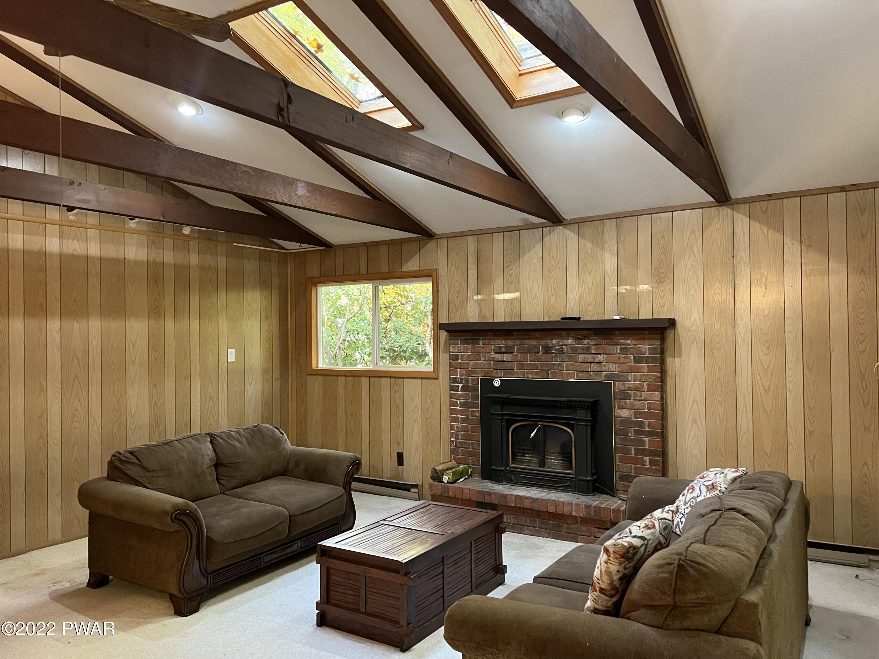 135 Rodeo Drive Hawley, PA 18428 - Photo 7 of 23 a living room with furniture and a fireplace