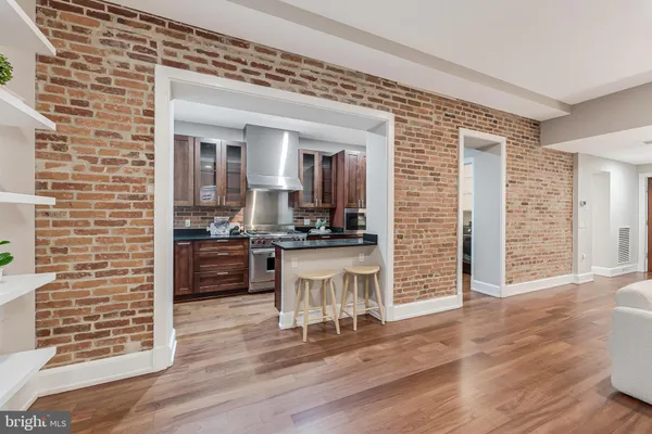 a kitchen with granite countertop a stove and cabinets