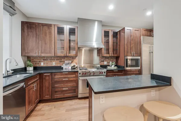 a kitchen with a stove a sink and a refrigerator
