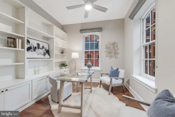 a living room with furniture and a book shelf