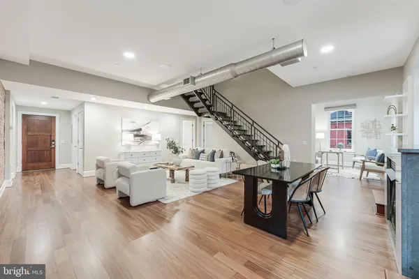 a living room with furniture and wooden floor