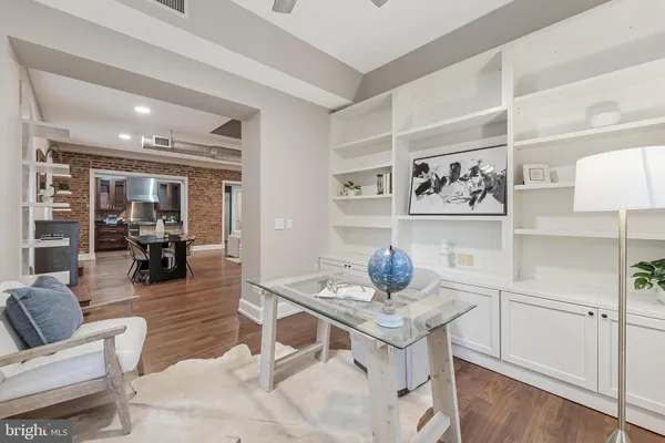 a living room with furniture and wooden floor