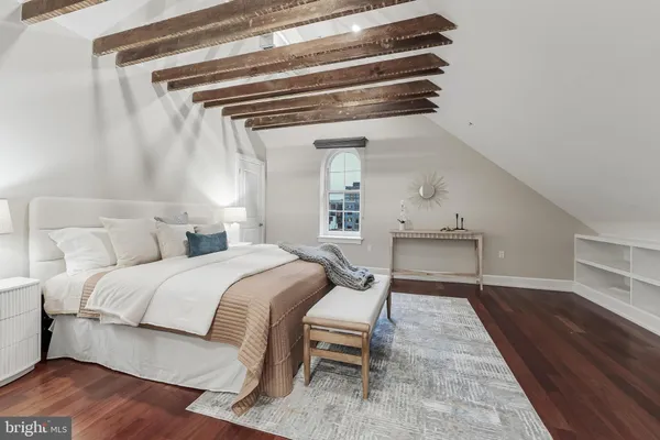 a bedroom with a bed and a table