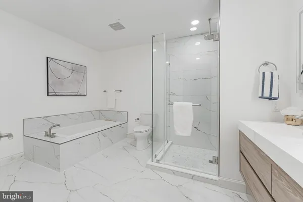 a bathroom with a shower sink and mirror