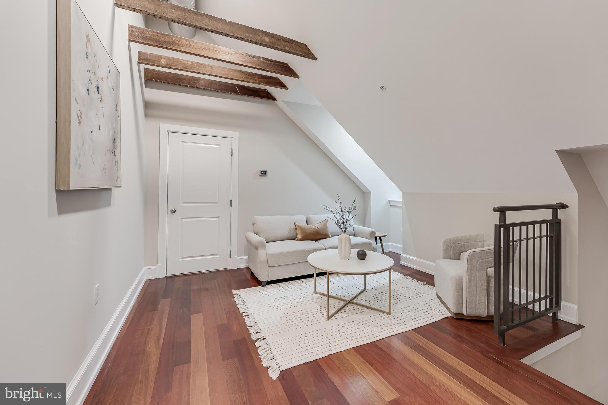 215 I Street Northeast, Unit 401 Washington, DC 20002 - Photo 29 of 36 a living room with furniture and a wooden floor