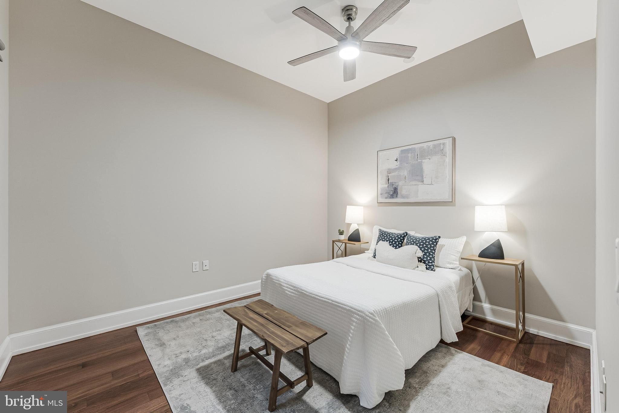 215 I Street Northeast, Unit 401 Washington, DC 20002 - Photo 30 of 36 a bedroom with a bed and a chandelier