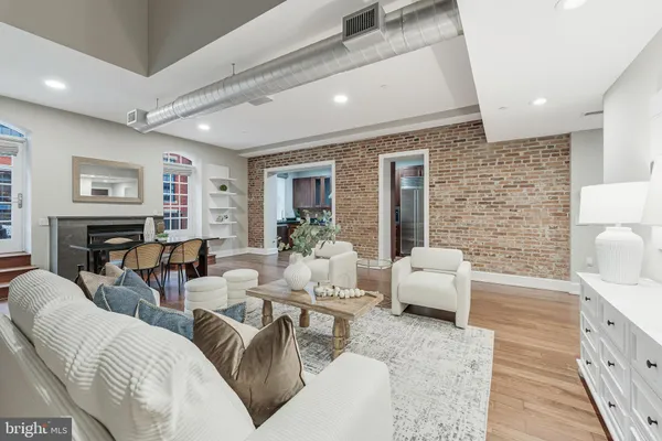 a living room with fireplace furniture and a fireplace