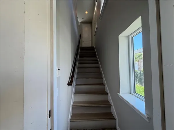 a view of entryway and hall with wooden floor