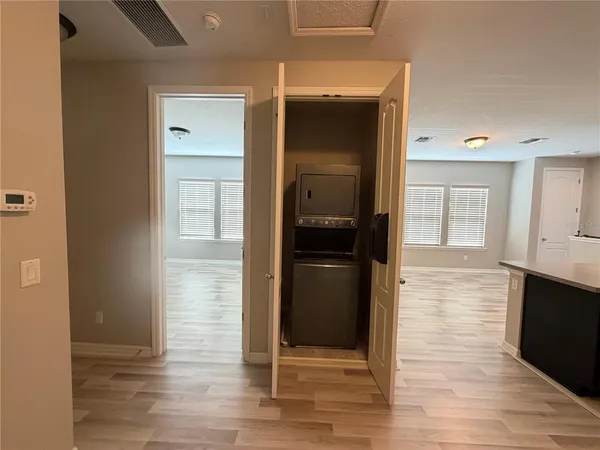 a view of hallway with wooden floor