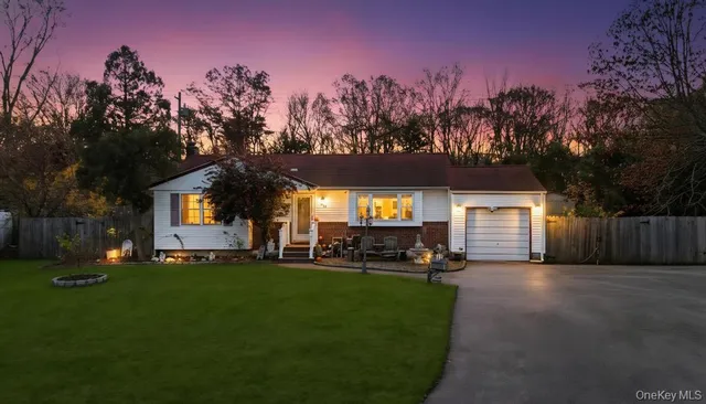 a view of a house with a yard and tree s