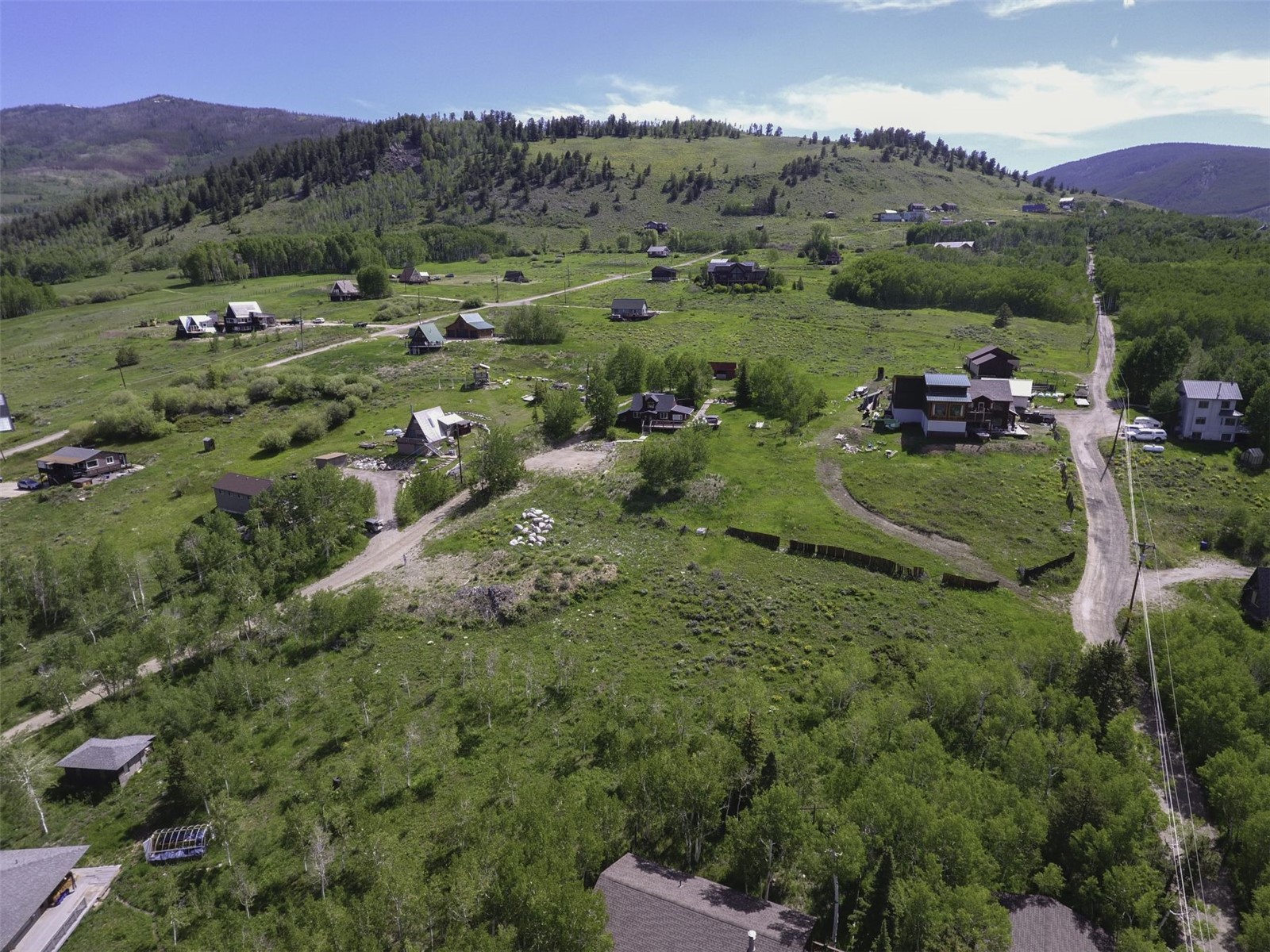71 V Road Silverthorne, CO 80498 - Photo 16 of 30 an aerial view of green landscape with trees houses and mountain view