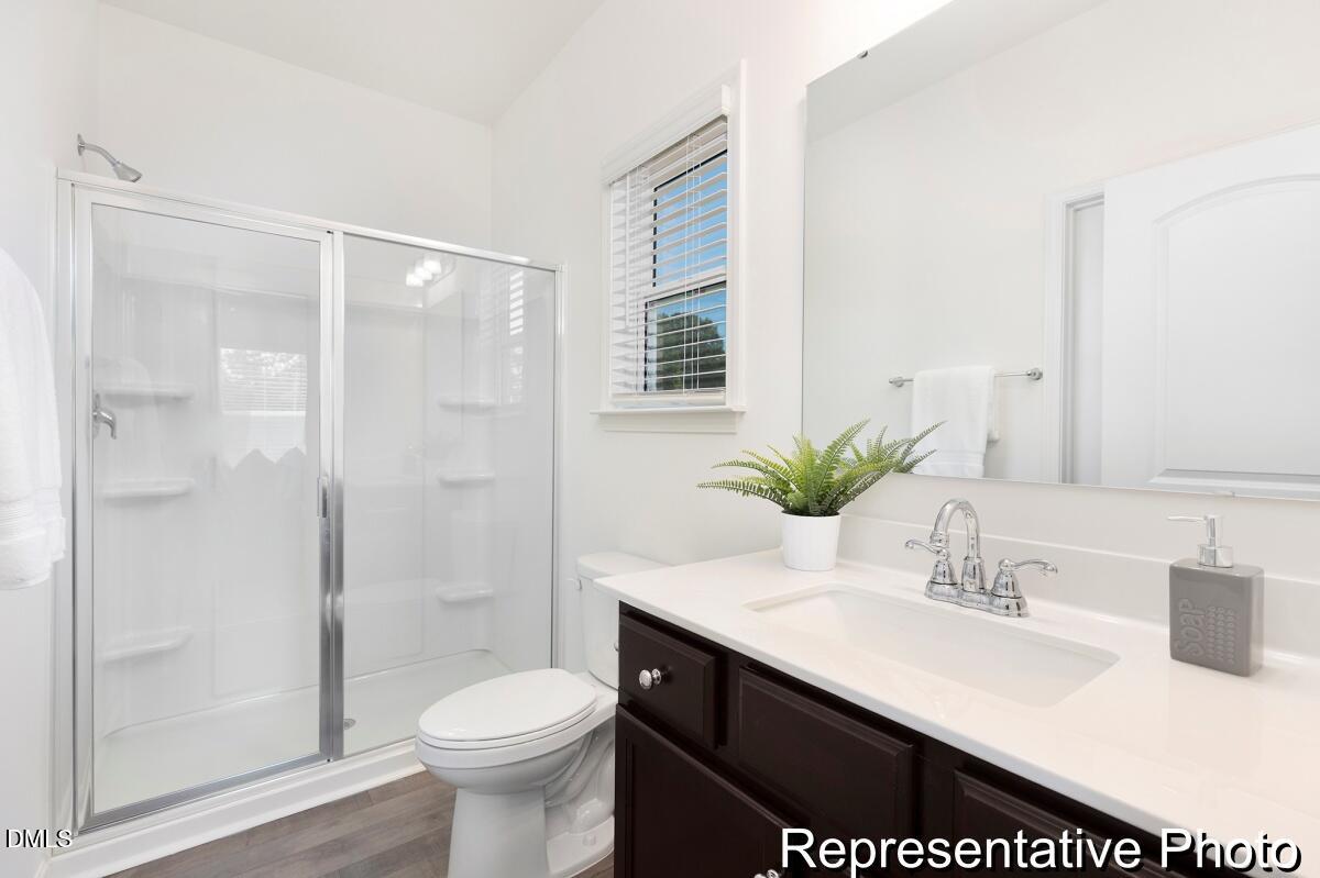 81 Cedarbranch Way, Unit 186P Dunn, NC 28334 - Photo 12 of 15 a bathroom with a sink a toilet and shower