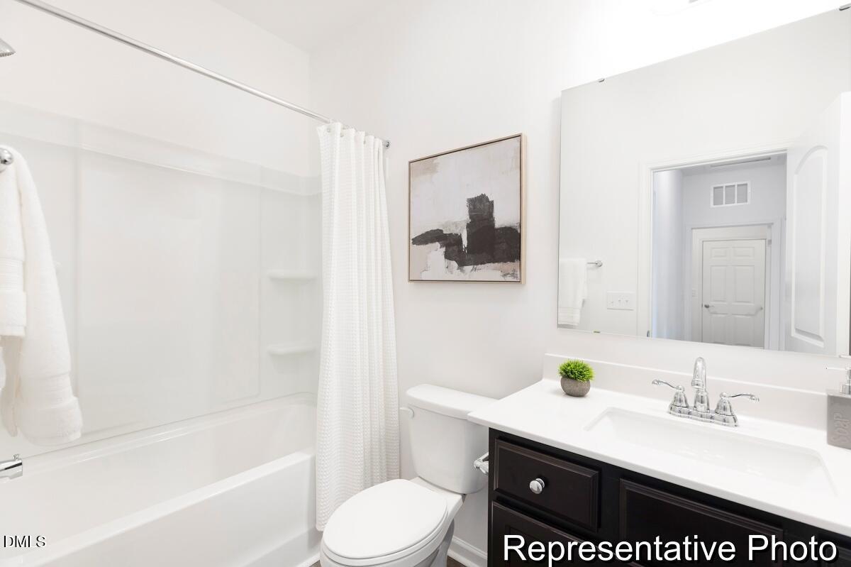 81 Cedarbranch Way, Unit 186P Dunn, NC 28334 - Photo 14 of 15 a bathroom with a granite countertop sink toilet and shower