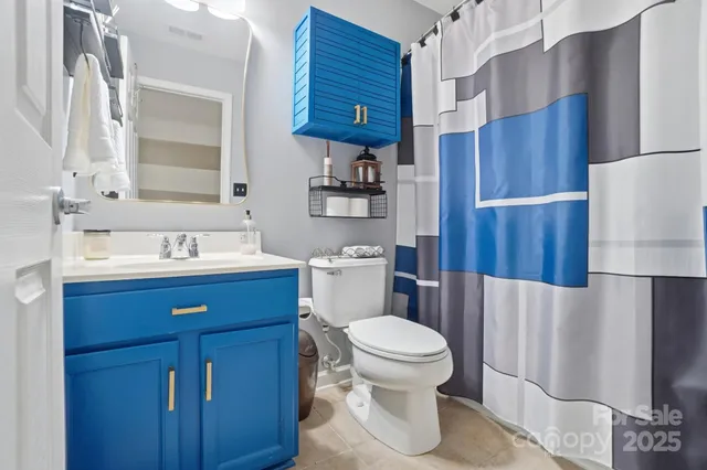 a bathroom with a sink a toilet and a mirror