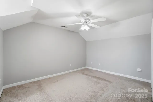 a view of an empty room with a fan