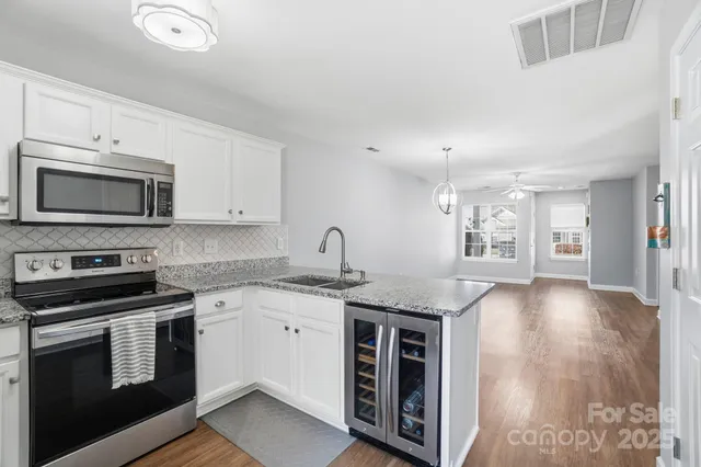 a kitchen with granite countertop a sink and cabinets