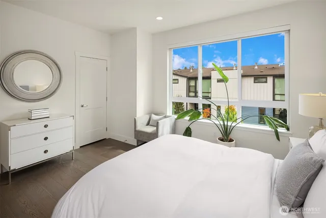 a bedroom with a bed a closet and wooden floor