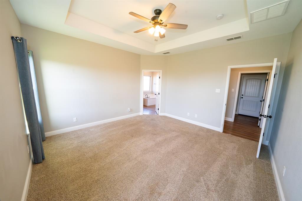 132 Addie Way Tuscola, TX 79562 - Photo 11 of 37 a view of a big room with closet and a chandelier fan