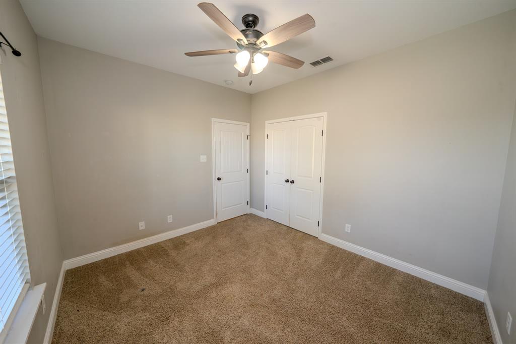 132 Addie Way Tuscola, TX 79562 - Photo 27 of 37 an empty room with a chandelier fan and a window