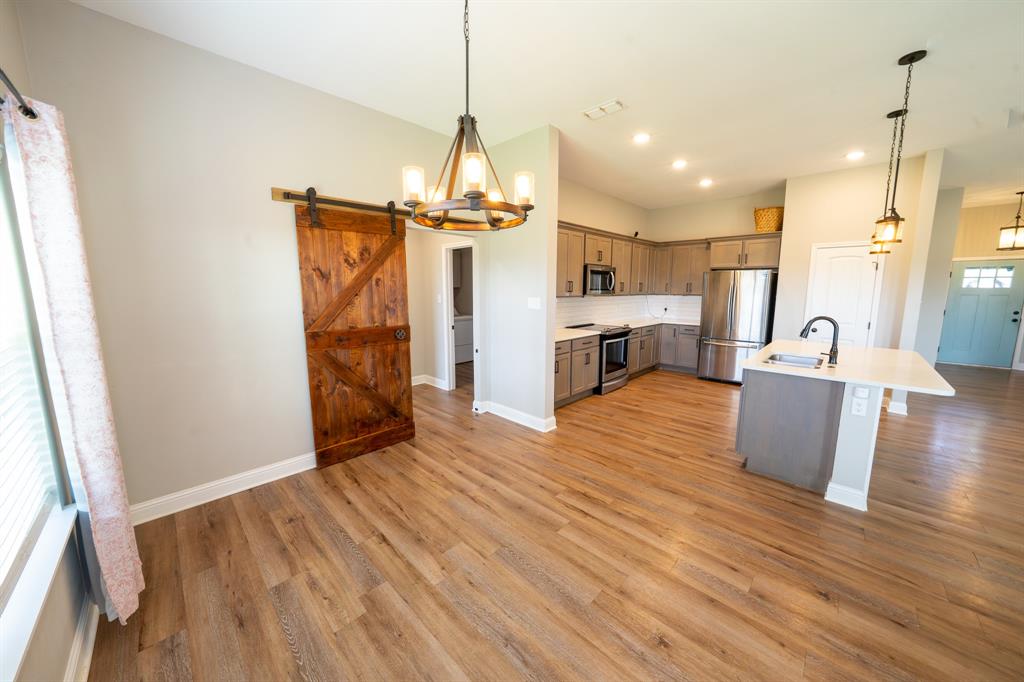 132 Addie Way Tuscola, TX 79562 - Photo 10 of 37 a view of a kitchen and a wooden floor